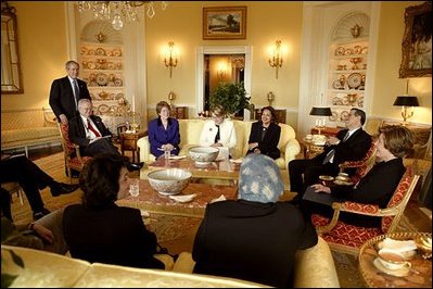 President George W. Bush drops a tea hosted by Mrs. Bush for the Iraqi Minister of Education, Dr. Ala'din Alwan, (seated next Mrs. Bush) in the White House Tuesday, Jan. 14, 2004.