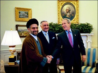 President Bush meets Iraqi Governing Council members Abdel-Aziz al-Hakim, left, and Dr. Adnan Pachachi in the Oval Office Jan. 20, 2004.