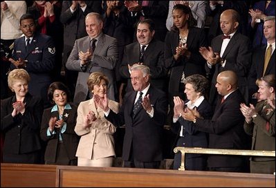 Mrs. Bush applauds her special guest, Dr. Adnan Pachachi, President of the Iraqi Governing Council, during President Bush's State of the Union Address at the U.S. Capitol Tuesday, Jan. 20, 2004. "Sir, America stands with you and the Iraqi people as you build a free and peaceful nation," said the President in his acknowledgement of Dr. Pachachi.