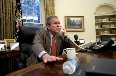 President George W. Bush speaks with British Prime Minister Tony Blair during a phone call in the Oval Office, Sunday morning, Dec. 14, 2003.