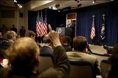 Discussing President George W. Bush takes questions during a press conference in the Dwight D. Eisenhower Executive Office Building Monday, Dec. 15, 2003.