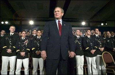 President George W. Bush stands on stage during his introduction before speaking on the war on terror at the Roswell Convention Center in Roswell, New Mexico, Thursday, Jan. 22, 2004.