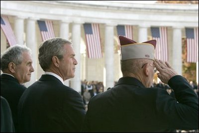 President George W. Bush stands with Secretary of Veterans Affairs Anthony Principi, left, and Mr. Gene Overstreet, President of the Non-Commissioned Officers Association, during the Veterans Day ceremonies at Arlington National Cemetery Nov. 11, 2004. "We honor every soldier, sailor, airman, Marine and Coastguardsman who gave some of the best years of their lives to the service of the United States and stood ready to give life, itself, on our behalf," said the President in his remarks. 
