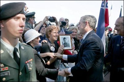 President George W. Bush meets with veterans and their families after delivering remarks during ceremonies marking the 60th anniversary of D-Day at the American Cemetery in Normandy, France, June 6, 2004.