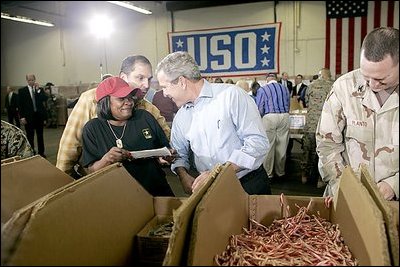 President George W. Bush visits Operation USO Care Package at Fort Belvior, Va., Friday, Dec. 10, 2004. "This is one way of saying, America appreciates your service to freedom and peace and our security," said the President in his remarks about the program that has delivered more than 480,000 care packages.