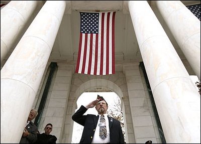 A veteran salutes as President George W. Bush speaks during ceremonies honoring Veterans Day at Arlington National Cemetery Nov. 11, 2004. "Our veterans are drawn from several generations and many backgrounds. They're Americans who remember the swift conflict of the Persian Gulf War; and a long Cold War vigil; the heat of Vietnam and the bitter cold of Korea. They are veterans in their 80s, who served under MacArthur and Eisenhower and saved the liberty of the world," said the President.