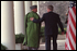 President George W. Bush and Chairman Karzai walk along the colonnade in the Rose Garden after their joint press conference Jan. 28. "The United States is committed to building a lasting partnership with Afghanistan," said the President. "We'll help the new Afghan government provide the security that is the foundation for peace."