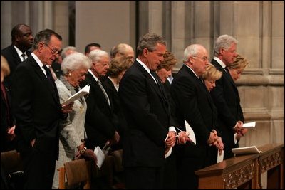 President George W. Bush bows his head during a prayer reading during the funeral service for former President Ronald Reagan at the National Cathedral in Washington, DC on June 11, 2004. 