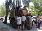 Afghan men unload a truck