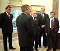 President Bush, Governor Ridge, Secretary Mineta, and others in the Oval Office on July 10, 2002. White House photo by Paul Morse.