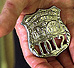President Bush holds the badge of a police officer killed in the September attacks. "And I will carry this," said President Bush during his address to Congress Sept. 20. "It is the police shield of a man named George Howard, who died at the World Trade Center trying to save others... It is a reminder of lives that ended, and a task that does not end."