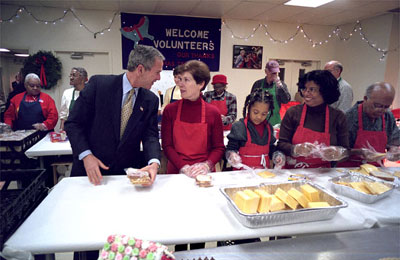 President George W. Bush talks with a volunteer at Martha's Table in Washington, D.C., December 20, 2001. A strong advocate of volunteerism, President Bush has challenged all Americans to donate 4,000 hours of community service during their lifetime.