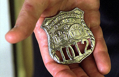 President Bush holds the badge of a police officer killed in the September attacks. 