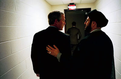 President George W. Bush speaks with Dr. Maha Hussain, President of Iraqi Forum for Democracy, at the Dearborn Ford Community and Performing Arts Center in Dearborn, Mich., April 28, 2003. 
