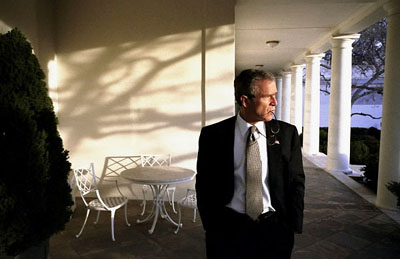 President George W. Bush takes an early morning walk from the Rose Garden to the Oval Office Feb. 15, 2002.