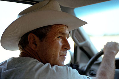 Driving along dusty roads at his ranch, President Bush gives a tour of his home in Crawford, Texas, August 7, 2001.