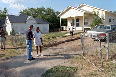 President George W. Bush visits with Waco, Texas residents after participating in a Habitat for Humanity home build on August 8, 2001.