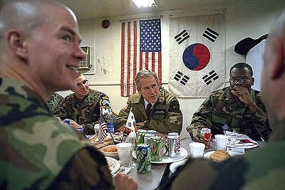 President Bush sits down with soldiers during a visit to Camp Bonifas in South Korea February 2, 2001.