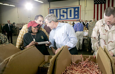 President George W. Bush visits Operation USO Care Package at Fort Belvior, Va., Friday, Dec. 10, 2004. "This is one way of saying, America appreciates your service to freedom and peace and our security," said the President in his remarks about the program that has delivered more than 480,000 care packages. White House photo by Paul Morse
