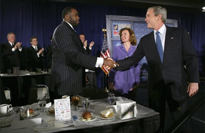 President George W. Bush greets Detroit Mayor Kwame Kilpatrick after delivering remarks at the Detroit Economic Club in Detroit, Michigan, Tuesday, Feb. 8, 2005. Also pictured at center is Detroit Economic Club President Beth Chappell. Laura Bush listens as boys participating in the Passport to Manhood program share ideas about respect and love during a visit to the Germantown Boys and Girls Club Tuesday, Feb. 3, 2005 in Philadelphia. Passport to Manhood promotes and teaches responsibility through a series of male club members ages 11-14.  White House photo by Eric Draper
