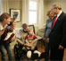 President George W. Bush and Laura Bush talk with U.S. Army Sgt. Dale Beatty of Statesville, N.C., and, from left, sister-in-law Wendolyn Summers, wife Belinda Beatty, son Lucas, 6 months old, and son Dustin, 2 years old, during a visit to the Fisher House at Walter Reed Army Medical Center in Washington, D.C., Tuesday, Dec. 21, 2004. President Bush presented Sgt. Beatty The Purple Heart for injuries he sustained while serving in Operation Iraqi Freedom.  White House photo by Paul Morse