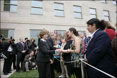 After placing a memorial wreath at the Pentagon, the President and Laura Bush greet audience members Monday, Sept. 11, 2006, during ceremonies marking the fifth anniversary of the September 11th attacks.