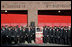 President George W. Bush and Laura Bush stand with New York City First Responders at the Fort Pitt Firehouse for a moment of silence Monday, September 11, 2006, in New York City to commemorate the fifth anniversary of the September 11th terrorist attacks. Also pictured is a door from Ladder 18, which was destroyed in the collapse of the World Trade Center.