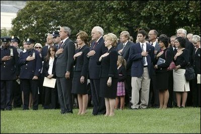 President George W. Bush, Mrs. Bush, Vice President Dick Cheney and Mrs. Cheney, stand by families of victims of 911 during the playing of Taps following a Moment of Silence on the South Lawn, Saturday, Sept. 11, 2004.