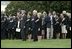 President George W. Bush, Mrs. Bush, Vice President Dick Cheney and Mrs. Cheney, stand by families of victims of 911 during the playing of Taps following a Moment of Silence on the South Lawn, Saturday, Sept. 11, 2004.
