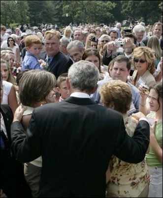 President George W. Bush meets some of the hundreds of family and friends who gathered on the South Lawn of the White House, Friday, Sept. 9, 2005, during the 9/11 Heroes Medal of Valor Award ceremony, in honor of the courage and commitment of emergency services personnel who died on Sept. 11, 2001.