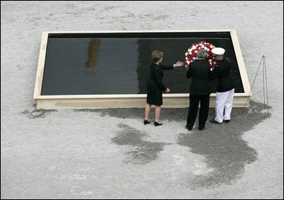 To commemorate the fifth anniversary of the terrorist attacks on September 11, 2001, President George W. Bush and Laura Bush lay a wreath in the south tower reflecting pool at the World Trade Center site in New York City Sunday, September 10, 2006.