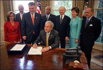 President George W. Bush signs into law H.R. 1, Implementing Recommendations of the 9/11 Commission Act of 2007, Friday, August 3, 2007, in the Oval Office.