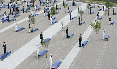 Military personnel stand at attention behind each of the 184 memorial benches draped in ceremonial cloths Thursday, Sept. 11, 2008, during the dedication of the 9/11 Pentagon Memorial at the Pentagon in Arlington, Va.