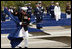 A Marine removes a ceremonial cloth during the unveiling of 184 memorial benches at the 9/11 Pentagon Memorial Thursday, Sept. 11, 2008, during the dedication of the 9/11 Pentagon Memorial at the Pentagon in Arlington, Va.