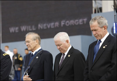 President George W. Bush is joined by former Secretary of Defense Donald Rumsfeld, left, and U.S. Secretary of Defense Robert Gates, as they bow their heads during a moment of silence Thursday, Sept. 11, 2008, during the dedication of the 9/11 Pentagon Memorial at the Pentagon in Arlington, Va.