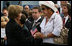 Mrs. Laura Bush speaks with a family member attending the Pentagon Memorial dedication ceremony Thursday, Sept. 11, 2008 at the Pentagon in Arlington, Va., where 184 memorial benches were unveiled honoring all innocent life lost when American Airlines Flight 77 crashed into the Pentagon on Sept. 11, 2001. 