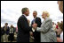President George W. Bush talks to relatives of the victims from Flight 93 after laying a wreath at the crash site in Somerset County Pennsylvania on September 11, 2002.