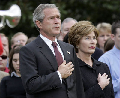 President George W. Bush and Mrs. Bush pause during the playing of Taps following the Moment of Silence on the South Lawn, Saturday, Sept. 11, 2004.