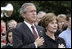 President George W. Bush and Mrs. Bush pause during the playing of Taps following the Moment of Silence on the South Lawn, Saturday, Sept. 11, 2004.
