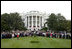 Honoring the memory of those who died during terrorist attacks on this day two years ago, President George W. Bush, Laura Bush, Vice President Dick Cheney and Lynne Cheney stand with White House staff for a moment of silence on the South Lawn 8:46 a.m., Thursday, Sept. 11, 2003.