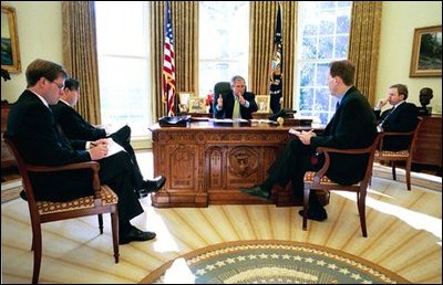 President George W. Bush meets with speechwriters to prepare for his State of the Union speech in the Oval Office Jan. 16, 2004. 