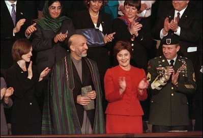 Hamid Karzai, center, Chairman of the Afghan Interim Authority, receives a standing ovation during President George W. Bush's State of the Union Address in the U. S. Capitol, Jan. 29, 2002.