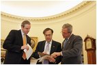 Advisors Dan Bartlett, left, and Mike Gerson work with President George W. Bush Tuesday, Feb. 1, 2005, in the Oval Office fine-tuning his State of the Union address scheduled to be delivered Wednesday night. 