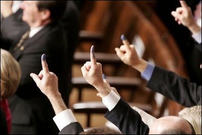 Members of Congress display purple ink-stained forefingers as a salute to voters in Sunday's Iraqi election, whose fingers were marked in a similar way, during President George W. Bush's State of the Union Address at the U.S. Capitol, Wednesday, Feb. 2, 2005. 