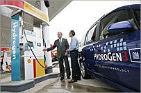 President George W. Bush talks to the media as he stands with Rick Scott, Operations and Safety Coordinator, Shell Hydrogen, L.L.C., Wednesday, May 25, 2005, at a Washington D.C. Shell Station, the first integrated gasoline/hydrogen station in North America. White House photo by Paul Morse