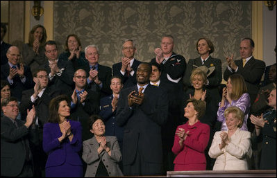 President George W. Bush recognizes Dikembe Mutombo of the Houston Rockets during the State of the Union Address at U.S. Capitol Tuesday, Jan. 23, 2007. "Dikembe became a star in the NBA, and a citizen of the United States," said President Bush. "But he never forgot the land of his birth, or the duty to share his blessings with others. He built a brand new hospital in his old hometown. A friend has said of this good-hearted man: "Mutombo believes that God has given him this opportunity to do great things." And we are proud to call this son of the Congo a citizen of the United States of America.