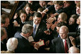 A flock of hands reach for President Bush as he signs his autograph after delivering the State of the Union Address in the House Chamber at the U.S. Capitol Tuesday, Jan. 23, 2007.