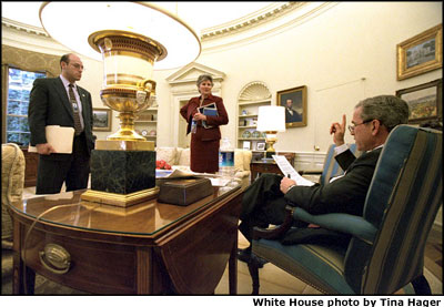 President Bush discusses some of the finer points of his upcoming State of the Union Address with Counselor Karen Hughes and Press Secretary Ari Fleischer in the Oval Office, Thursday,Jan. 24. White House photo by Tina Hager.