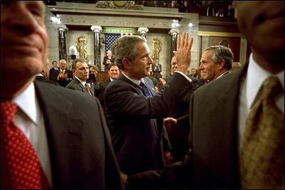 After delivering his State of the Union speech, President Bush waves to his wife, Laura Bush, as he leaves the House Chamber at the U.S. Capitol Tuesday, Jan. 28, 2003. 