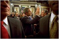 After delivering his State of the Union speech, President Bush waves to his wife, Laura Bush, as he leaves the House Chamber at the U.S. Capitol Tuesday, Jan. 28, 2003. 